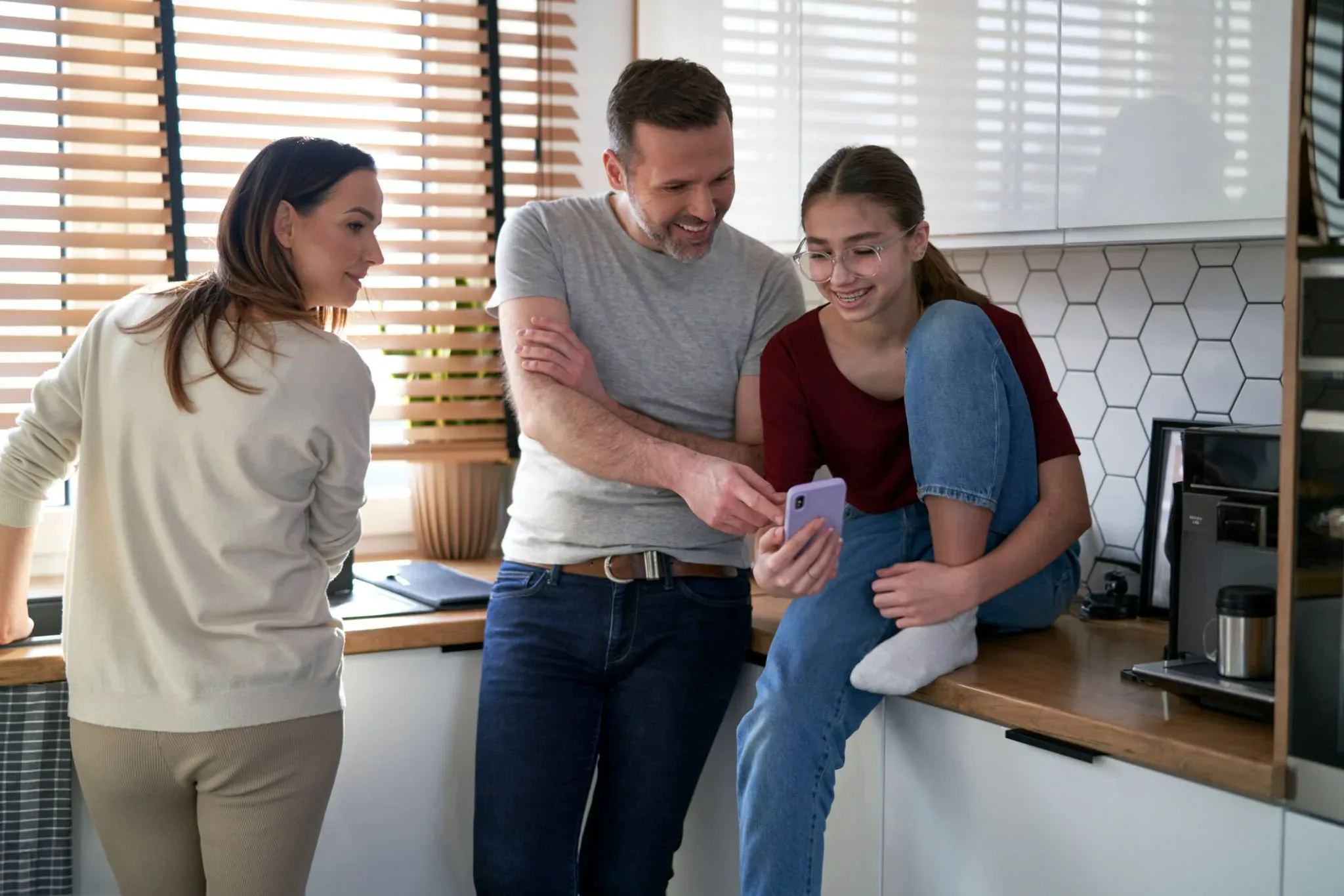 A family reading a local government update together on a phone at home