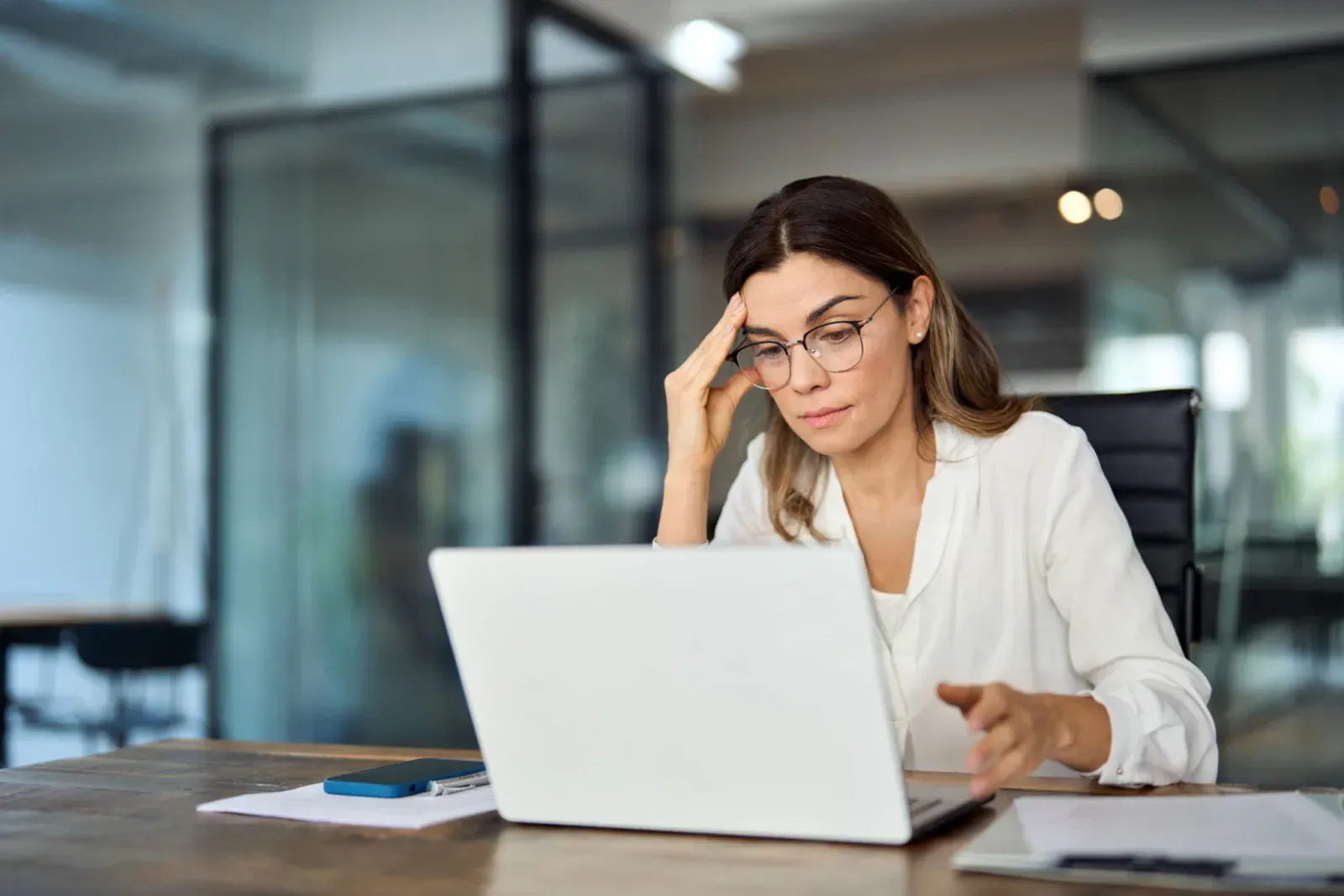 A government communications worker looking frustrated at her computer