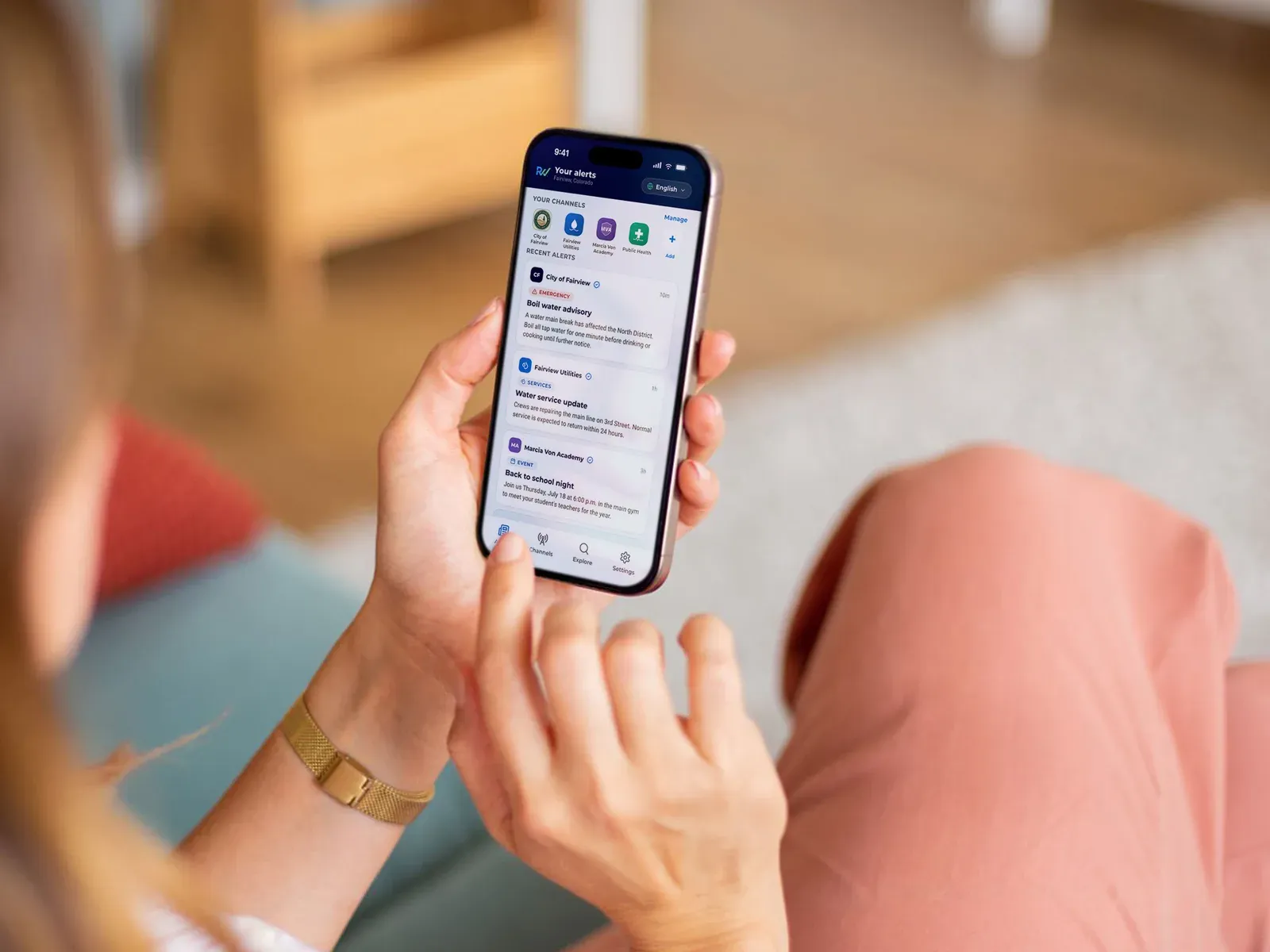 A resident scrolling recent alerts from their city, utility, and school district in the ReachWell app